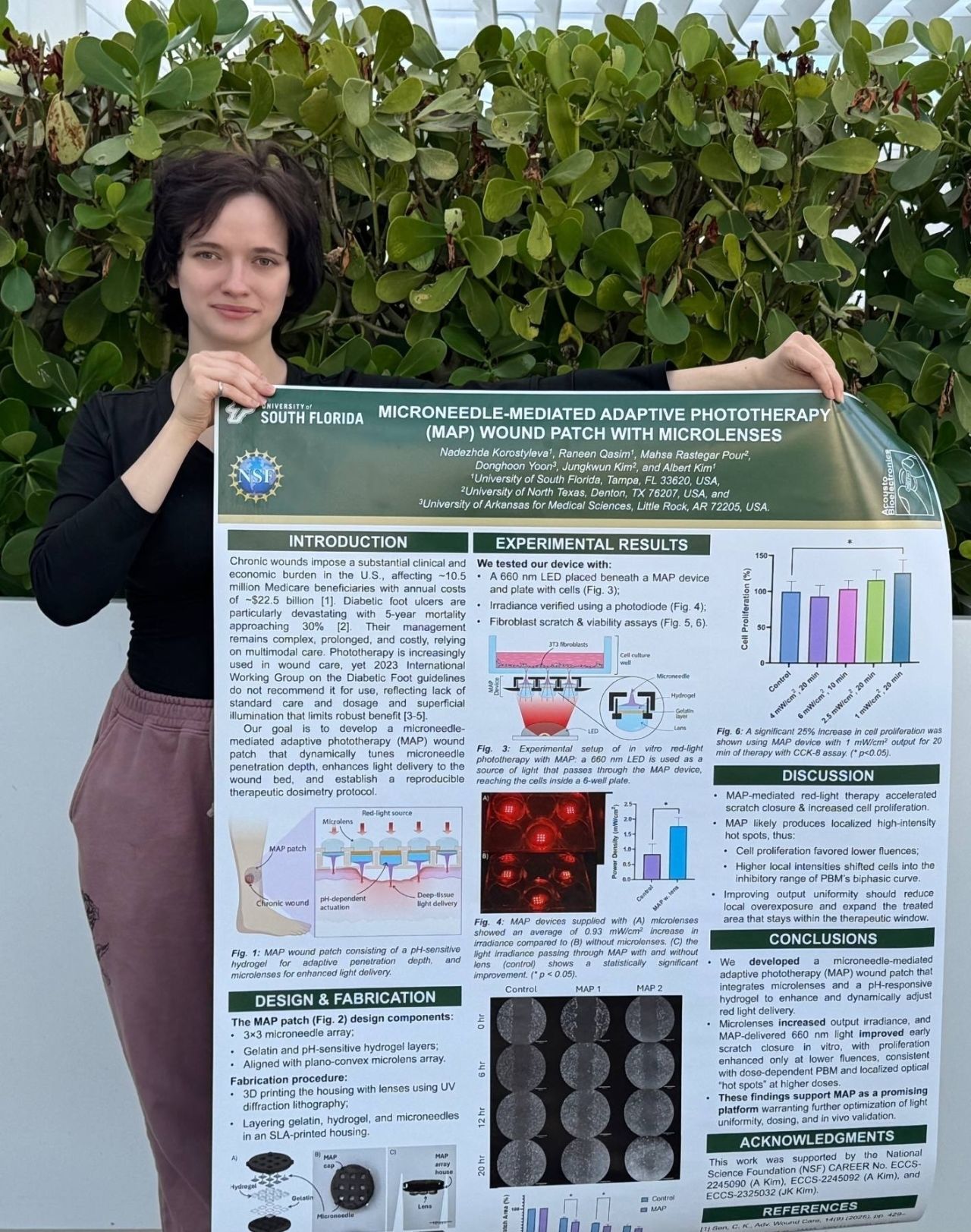 Holding the IEEE MEMS 2026 poster, titled Microneedle-Mediated Adaptive Phototherapy (MAP) Wound Patch with Microlenses.