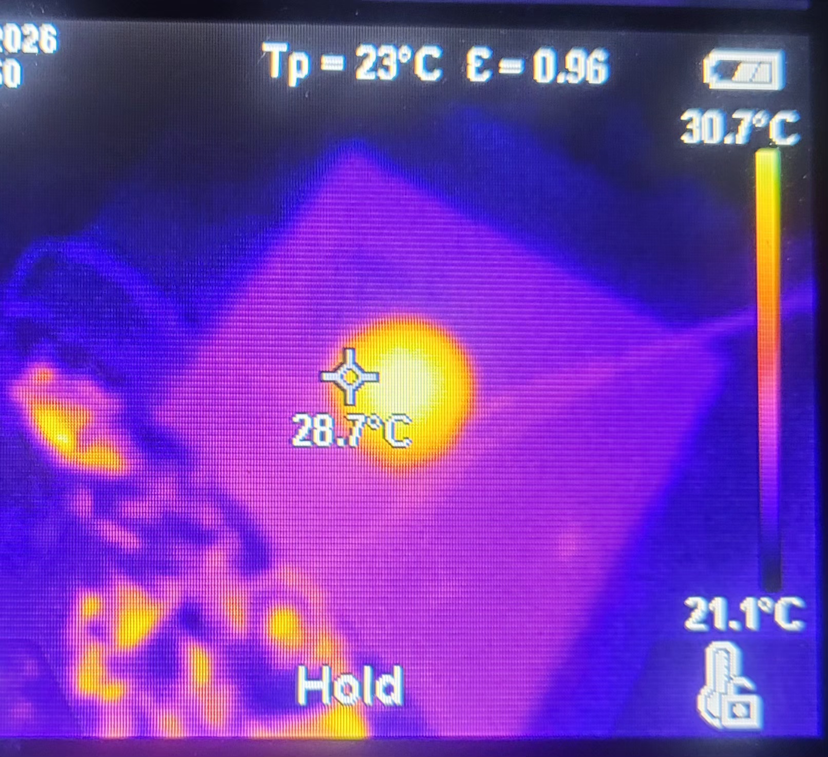 The LED source array running, individual emitters visible through the lens optic against saturated red illumination.